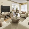 Beautiful living area with wall mounted TV, coffee table, and furniture