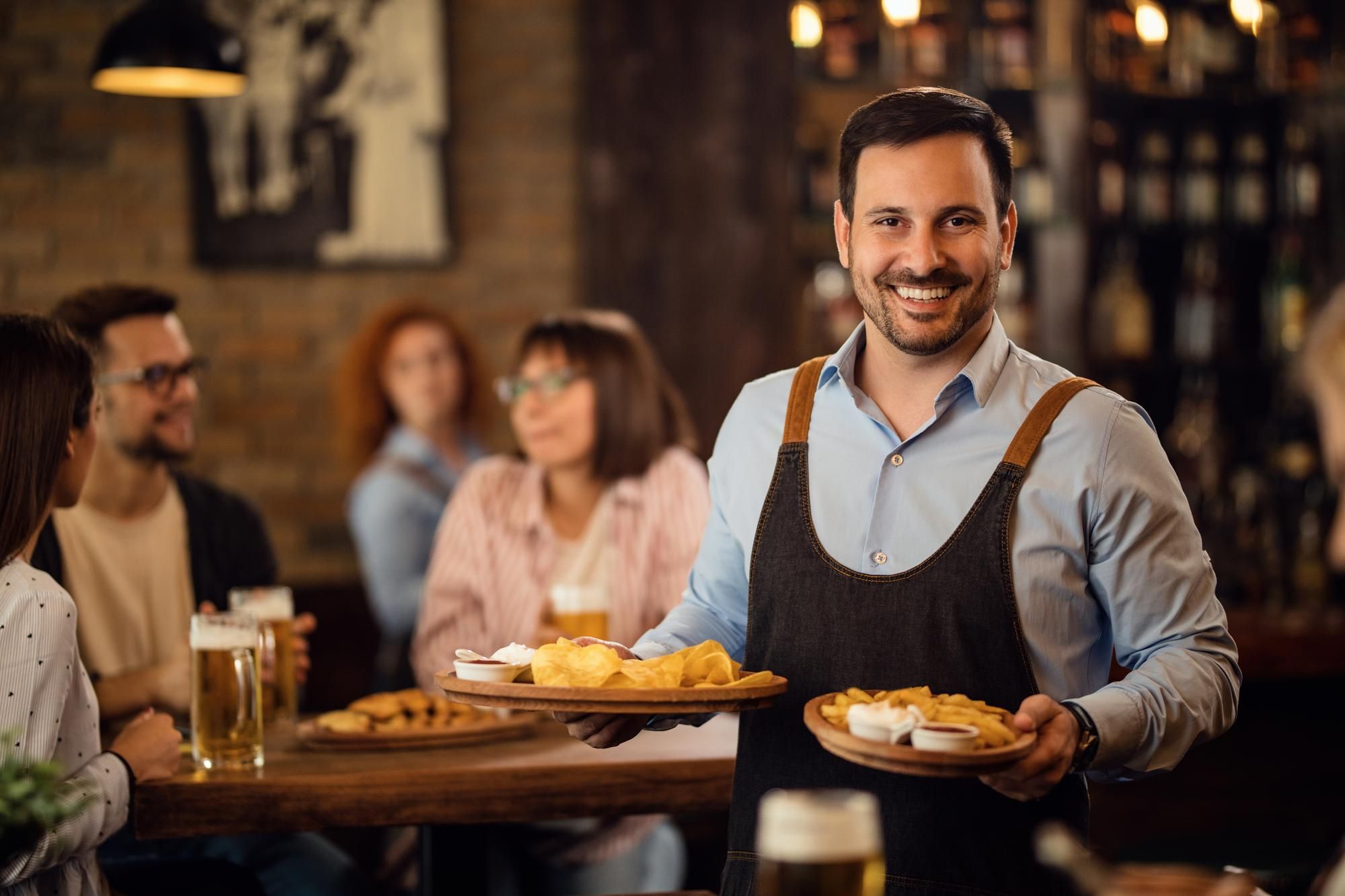 Cosgrove Hill at Chapel Hiil, NC. A waiter carrying plates of food in a restaurant.