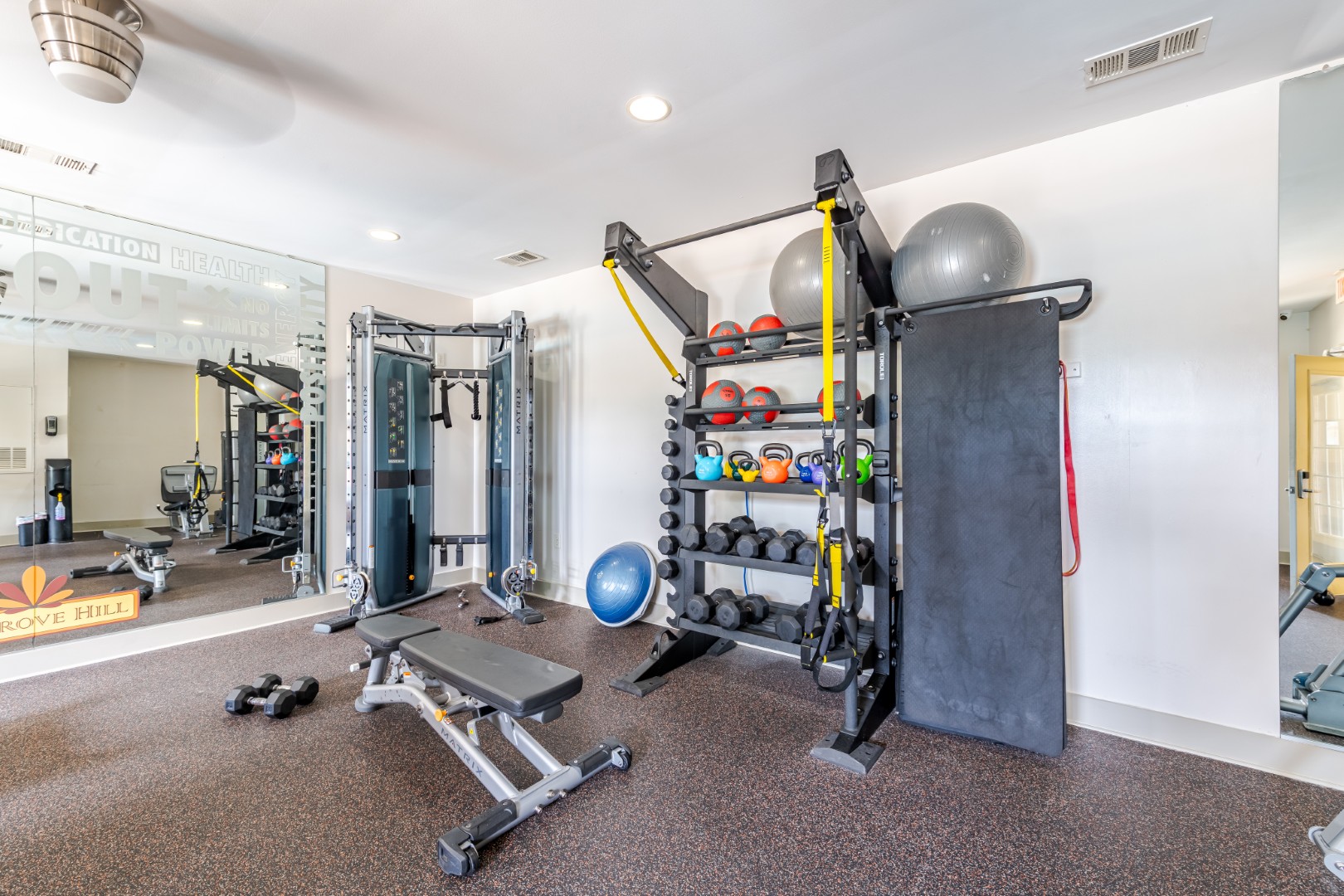 Cosgrove Hill at Chapel Hiil, NC Fitness center with treadmills, weights, and mirrors for workouts.