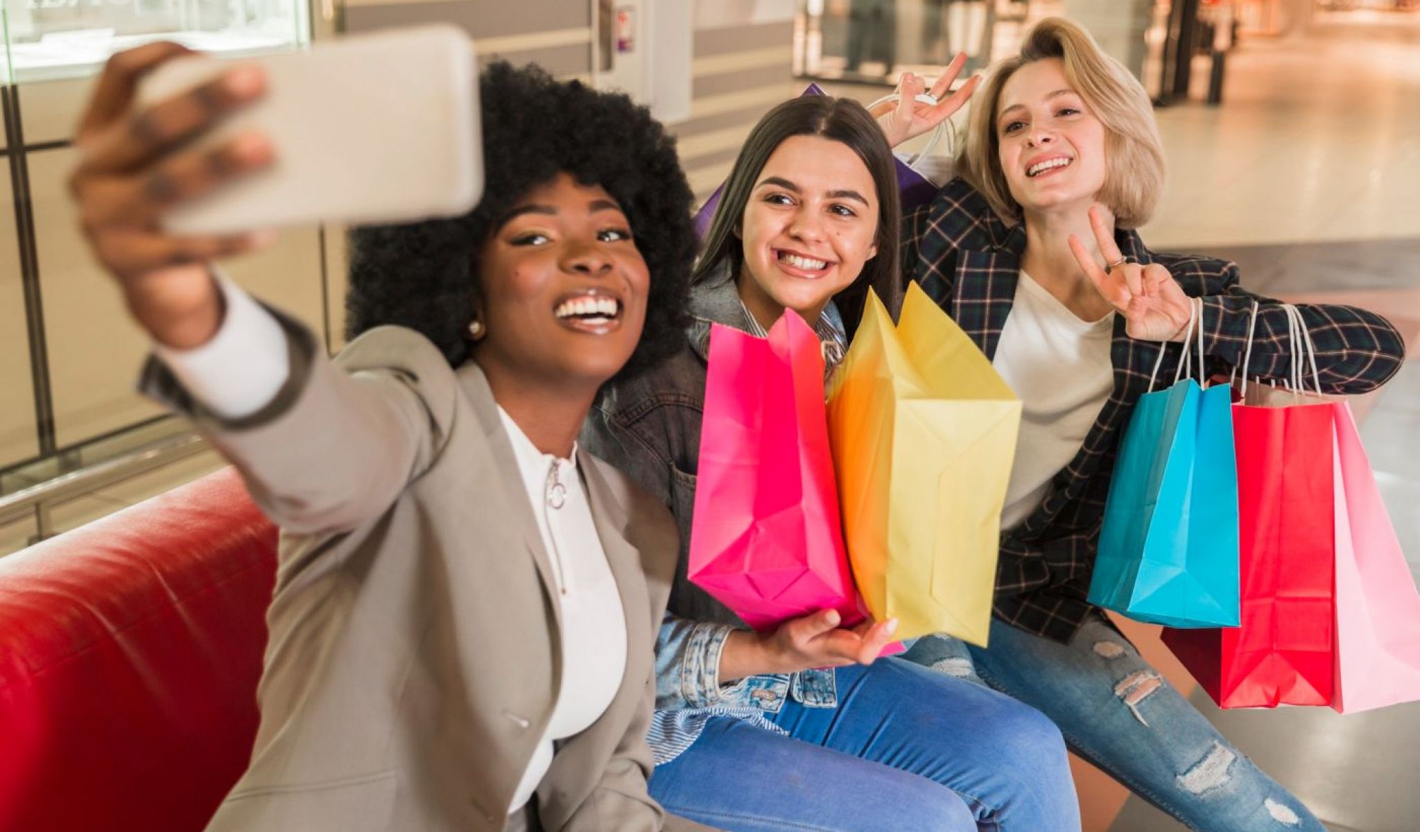 Cosgrove Hill at Chapel Hiil, NC. Three women smiling and taking a selfie with their phones while shopping.